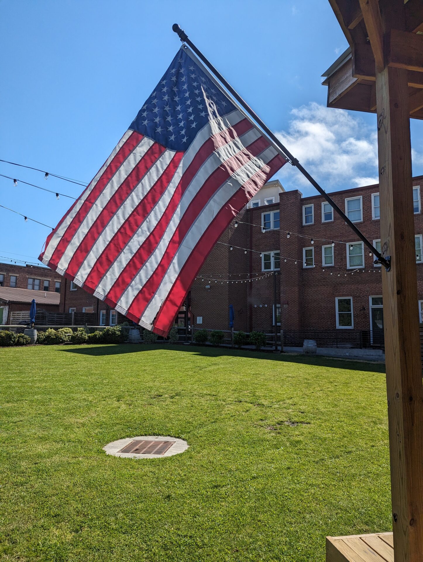 An American flag hanging outside of the Western Front Hotel on a sunny day.